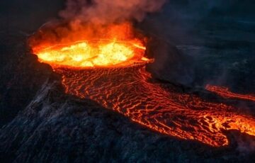 An erupting volcano and lava flow. Image: Nikolay Zaborskikh / Shutterstock.