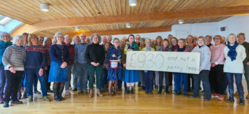 The Suitcase Singers present a cheque for £930 to ShelterBox. Image: ShelterBox.