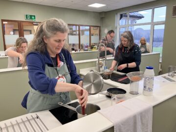 Westbank Wellbeing Day: the team cooking up healthy lunch options in the Community Cookery School. Image provided by Sharon Goble / If Media.