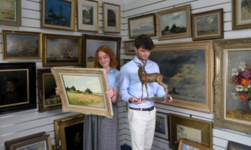 Auctioneers Mary Chilcott and Barnaby Willis with Captain Campbell’s Collection. Image: Chilcotts.