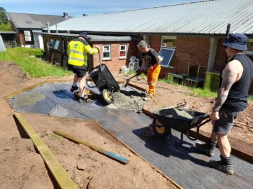 Westbank Community Allotment: three volunteers from Kier laying the new pathway (image supplied by Kier).