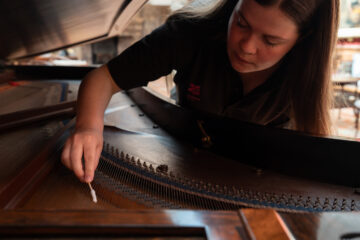 Conservation cleaning of the Broadwood piano at Cragside. Image provided by The National Trust.