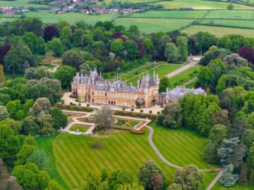 An aerial view of Waddesdon Manor atop a hill surrounded by lush green fields in Buckinghamshire. Image: Wirestock Creators / Shutterstock.