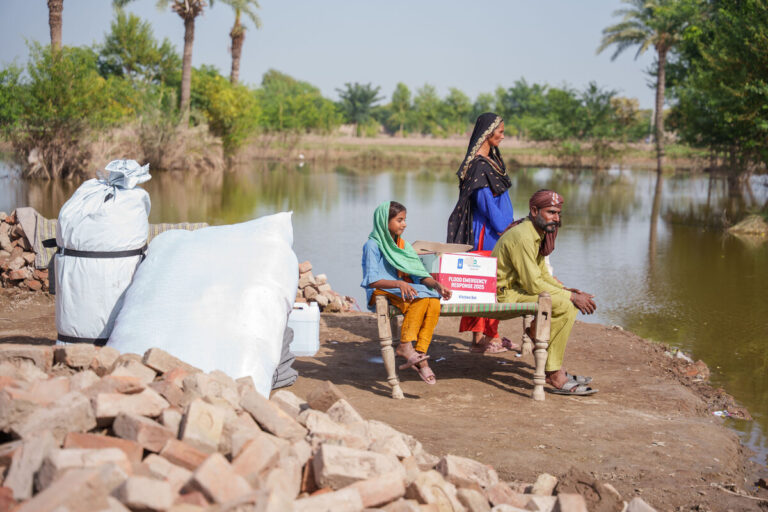 A family supported by ShelterBox and Islamic Relief Pakistan after severe flooding in Pakistan. Image provided by ShelterBox.