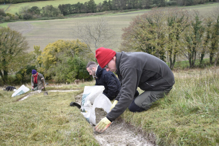 National Trust staff and volunteers re-chalking the Cerne Giant, Dorset. Image: © Clive Whitbourn, National Trust Images.