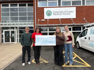 Westbank’s Head of Fundraising, Katie Elliott (second from the left), being presented with a cheque by students at Exeter Medical School. Image provided by If Media.