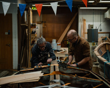 Bob White (left), Boat Collection Manager at National Maritime Museum Cornwall with Wyl Menmuir (right). Image provided by Katie Wild Content.